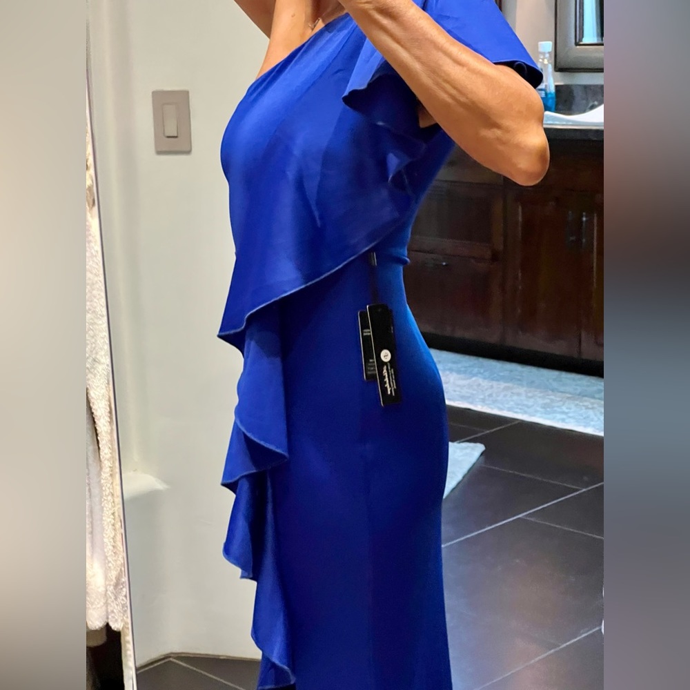 Size “S”, new with tags. Stunning Royal Blue gown lined.